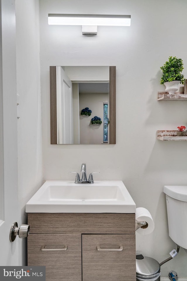 bathroom featuring toilet and vanity