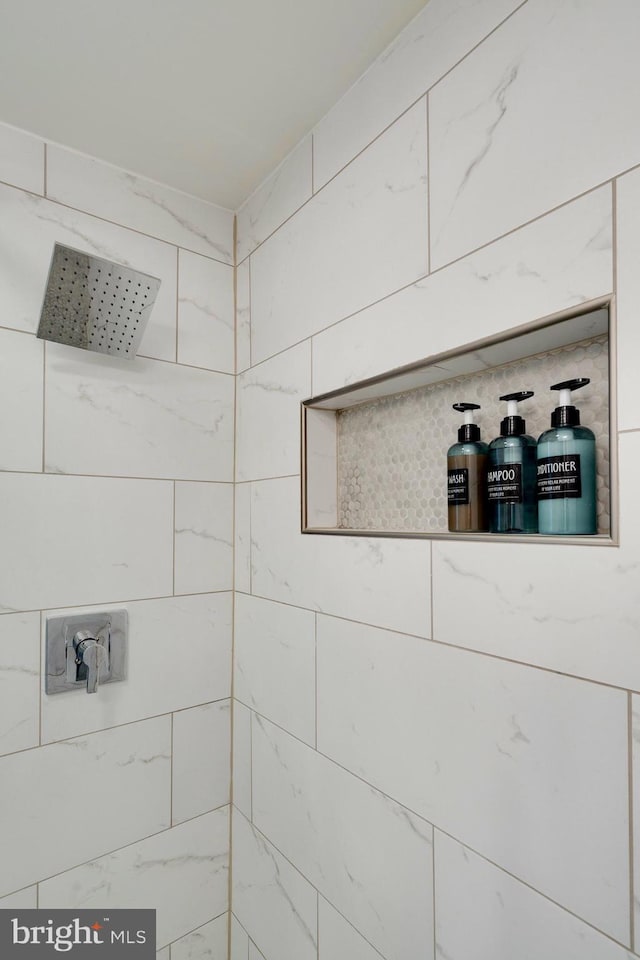 bathroom with tiled shower