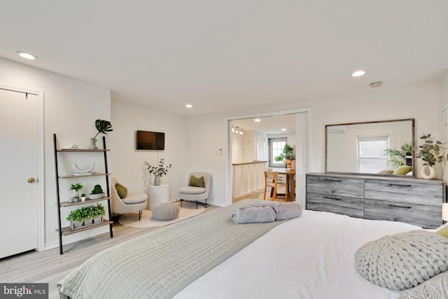 bedroom featuring multiple windows and light hardwood / wood-style floors