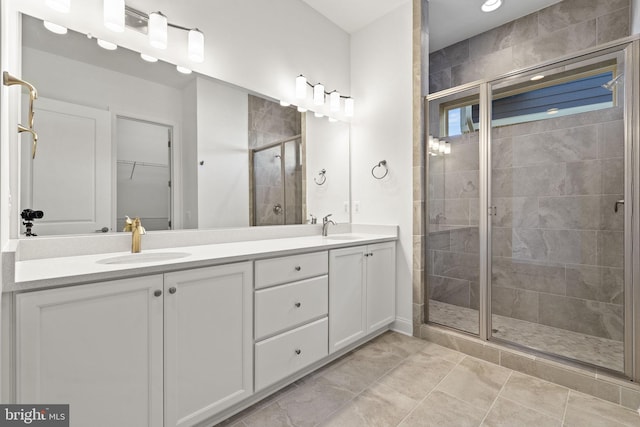 bathroom with tile patterned floors, vanity, and walk in shower