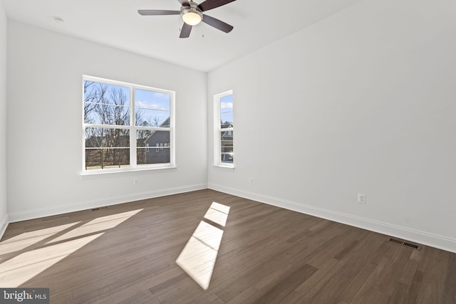 empty room featuring ceiling fan and dark wood-type flooring