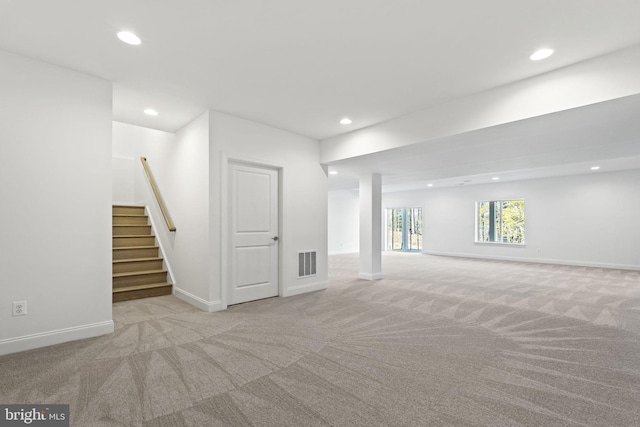 basement featuring light colored carpet