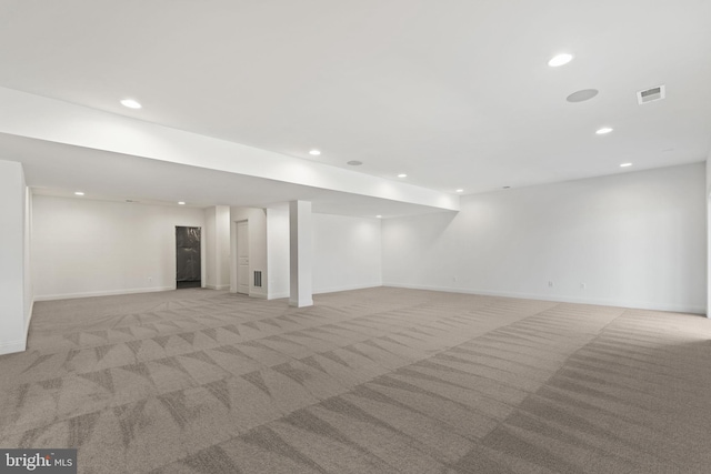 basement featuring light colored carpet