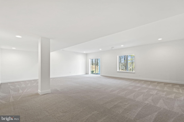 basement featuring light carpet