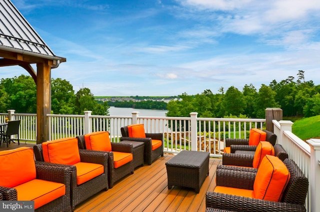 wooden deck with outdoor lounge area and a water view