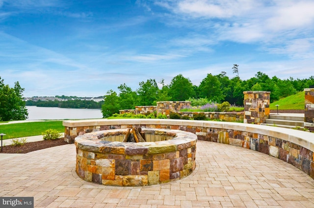 view of patio / terrace featuring a water view and an outdoor fire pit