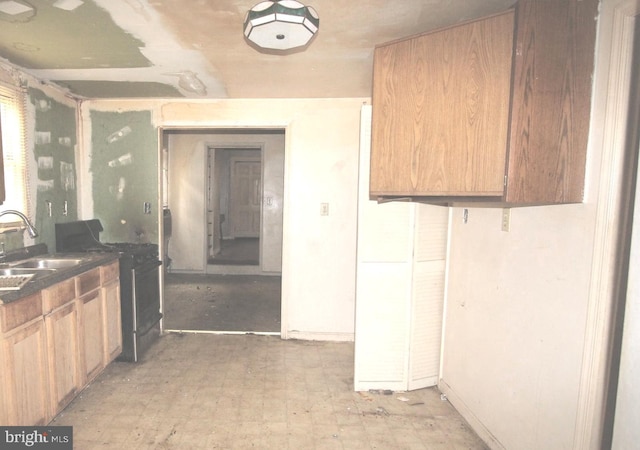 kitchen featuring sink, washer / clothes dryer, and light tile floors