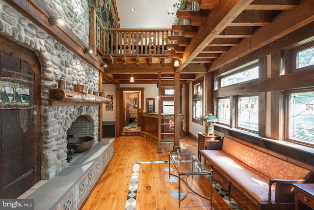 3111 Burnt House Hill Rd, Doylestown, PA 18902 - living room featuring a high ceiling, a stone fireplace, and light wood-type flooring