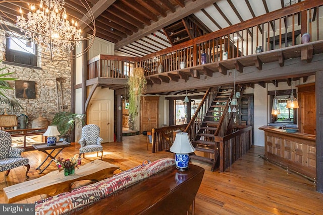 3111 Burnt House Hill Rd, Doylestown, PA 18902 - living room with high vaulted ceiling, an inviting chandelier, light hardwood / wood-style floors, and a healthy amount of sunlight