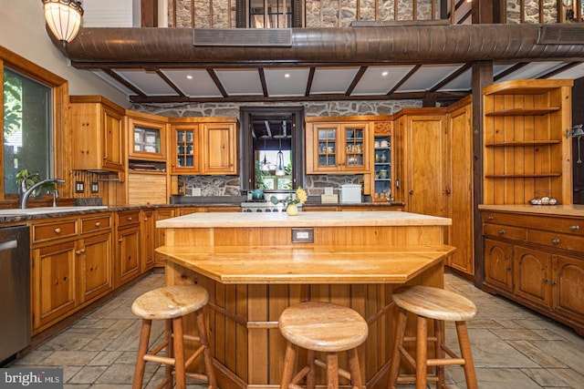 3111 Burnt House Hill Rd, Doylestown, PA 18902 - kitchen with a breakfast bar, a kitchen island, light tile floors, wooden counters, and sink