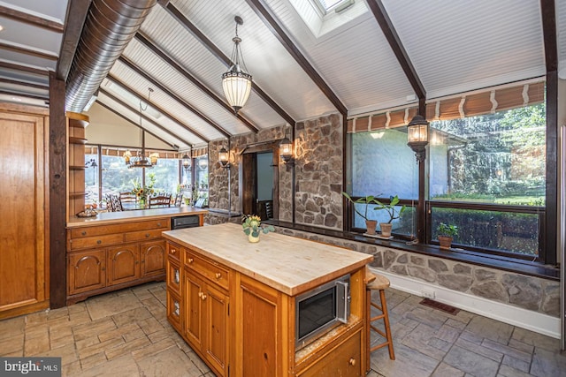 3111 Burnt House Hill Rd, Doylestown, PA 18902 - kitchen with a skylight, hanging light fixtures, stainless steel microwave, a notable chandelier, and light tile floors