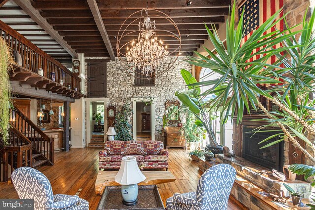 3111 Burnt House Hill Rd, Doylestown, PA 18902 - living room with an inviting chandelier, beam ceiling, dark hardwood / wood-style floors, and a healthy amount of sunlight