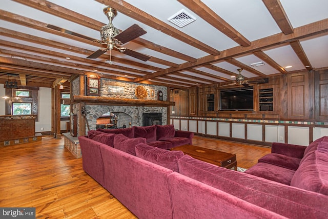 3111 Burnt House Hill Rd, Doylestown, PA 18902 - living room with a stone fireplace, ceiling fan, light wood-type flooring, and beamed ceiling