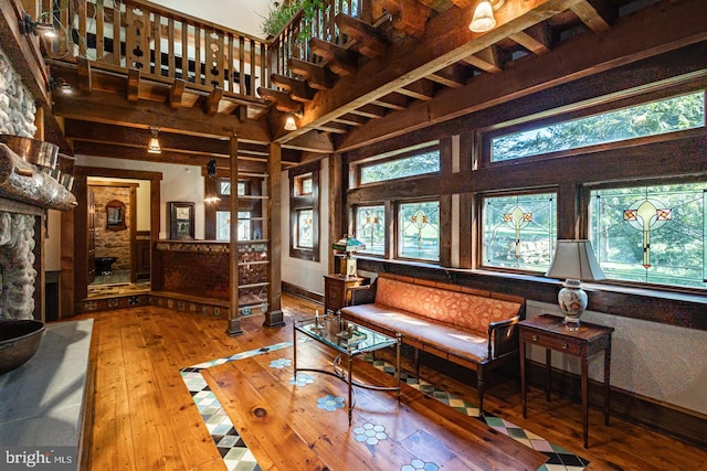 3111 Burnt House Hill Rd, Doylestown, PA 18902 - sitting room featuring plenty of natural light, a towering ceiling, a stone fireplace, and light wood-type flooring