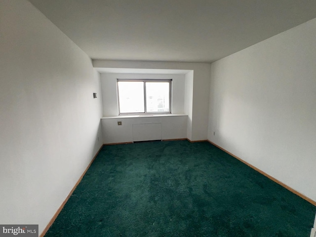 empty room with dark carpet