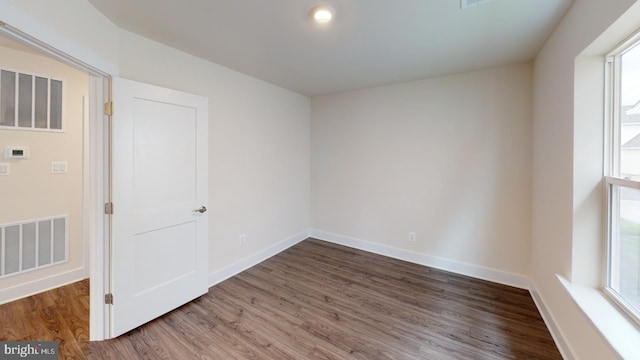 empty room featuring dark wood-type flooring