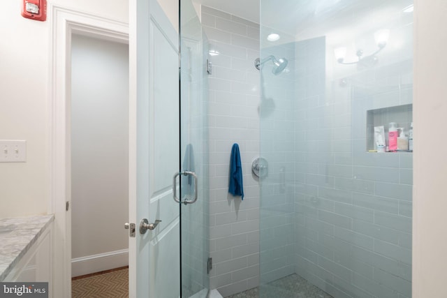 bathroom with a shower with shower door