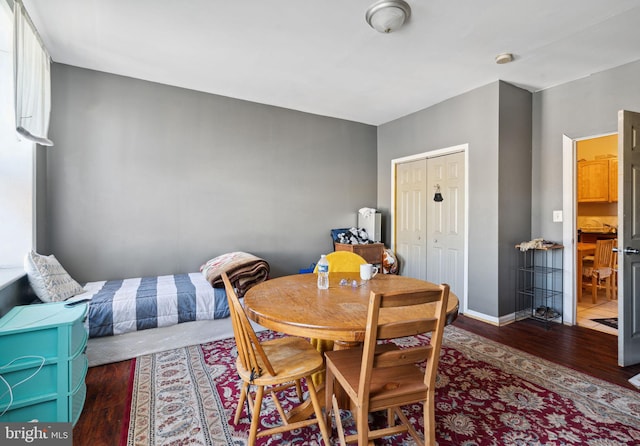 dining area featuring dark tile floors