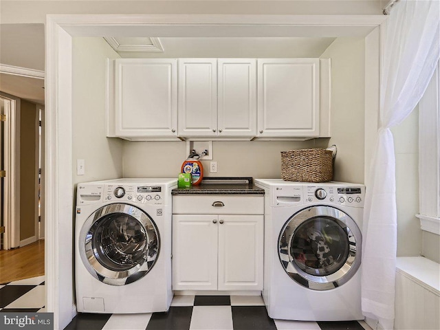 laundry area featuring washer and dryer, crown molding, cabinets, and dark tile flooring