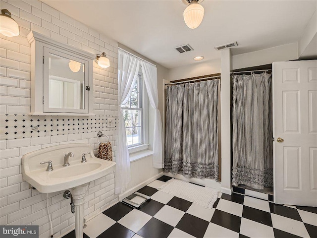 bathroom with tile walls and tile floors