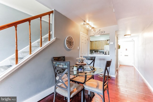 dining area featuring track lighting and light wood-type flooring