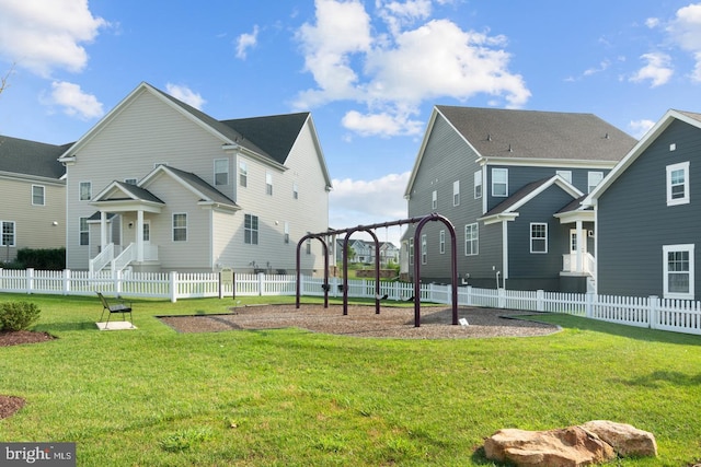 exterior space with a playground and a lawn