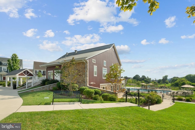 exterior space with a yard, a gazebo, and a fenced in pool