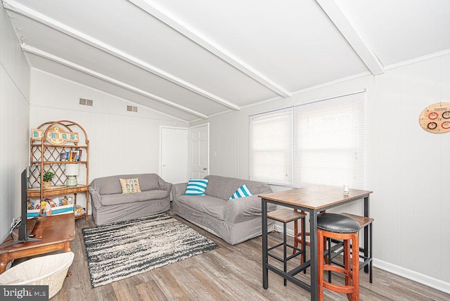 living room with vaulted ceiling with beams and light hardwood / wood-style floors