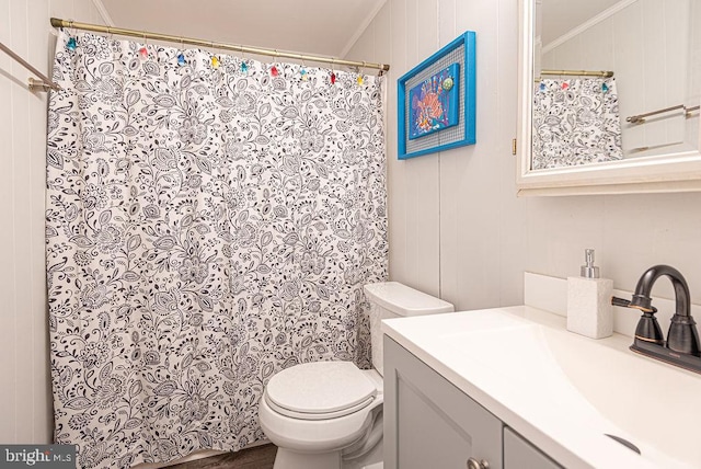 bathroom featuring vanity, crown molding, and toilet