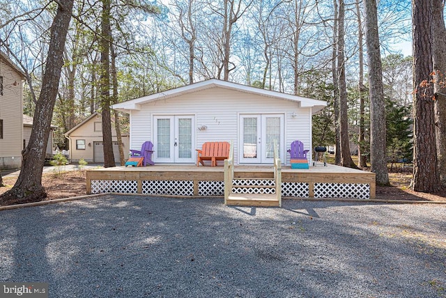 view of front of house featuring a deck and french doors