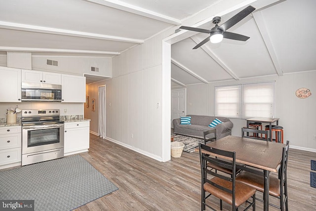 kitchen with vaulted ceiling with beams, ceiling fan, light hardwood / wood-style floors, white cabinets, and range with electric cooktop