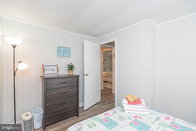 bedroom featuring dark hardwood / wood-style flooring and crown molding