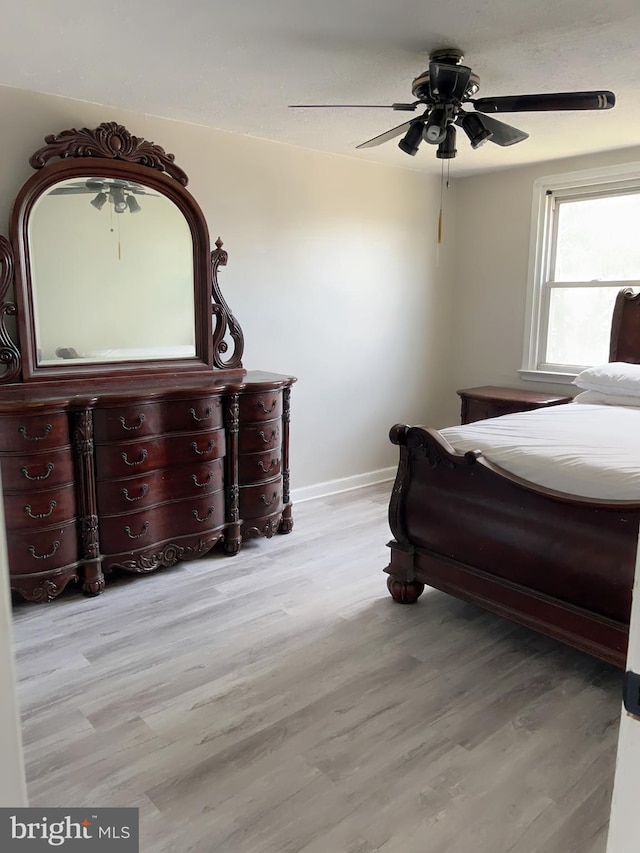 bedroom with ceiling fan and light hardwood / wood-style floors