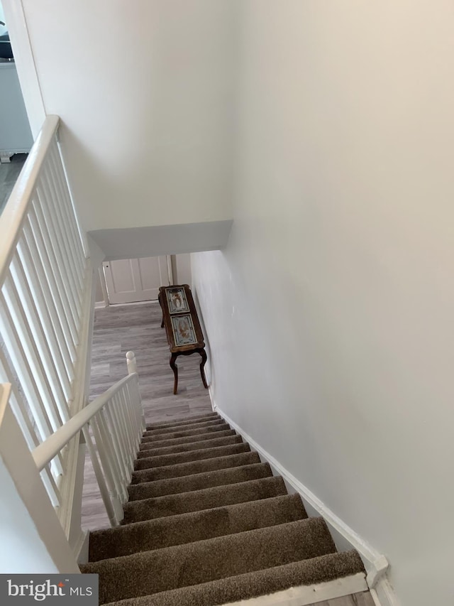 staircase featuring hardwood / wood-style floors