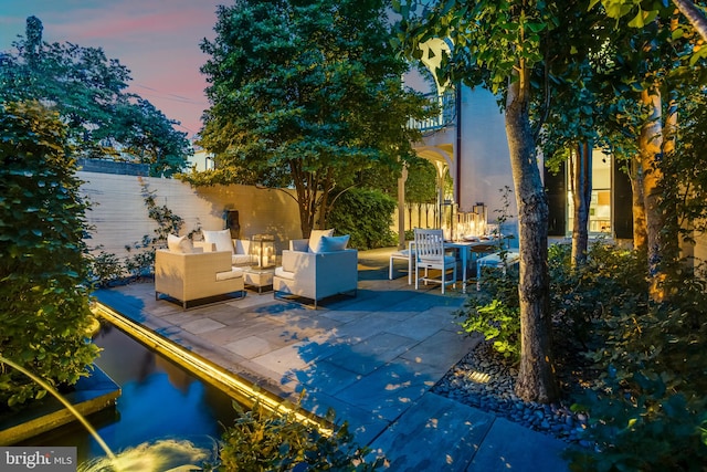 patio terrace at dusk with an outdoor living space