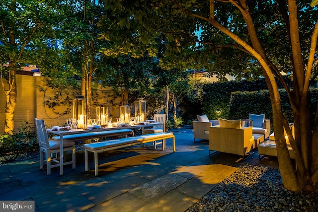 view of patio with an outdoor living space with a fire pit