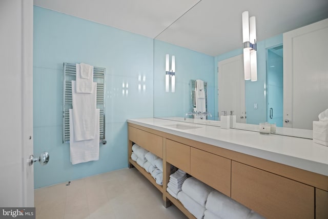 bathroom featuring radiator and vanity