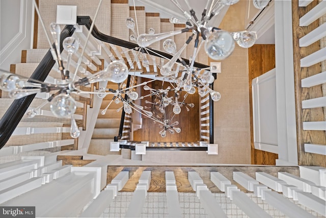 interior details with a chandelier and wooden walls