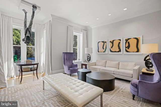 living room featuring a wealth of natural light, light hardwood / wood-style flooring, and crown molding