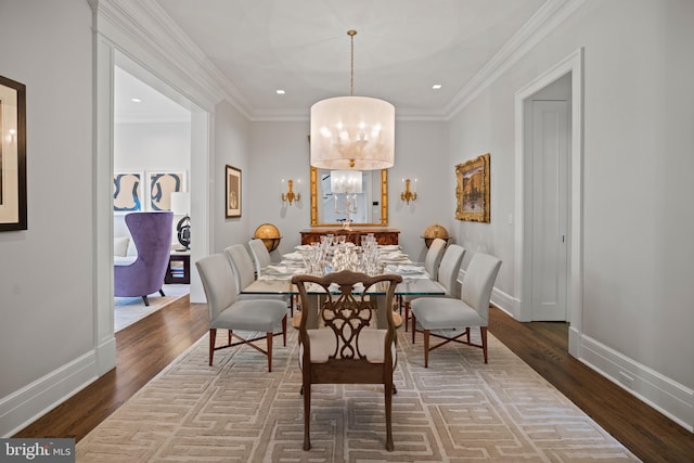 dining area featuring a chandelier, ornamental molding, and dark hardwood / wood-style flooring