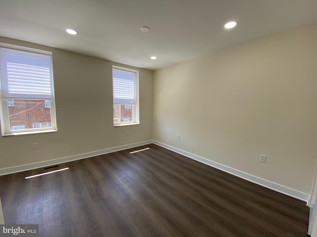 spare room with dark wood-type flooring