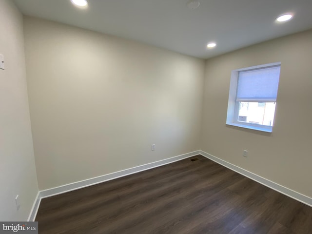 spare room featuring dark hardwood / wood-style floors