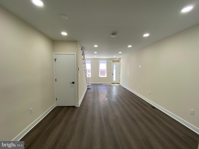 empty room with dark hardwood / wood-style floors