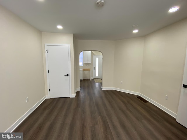 unfurnished room with dark hardwood / wood-style flooring