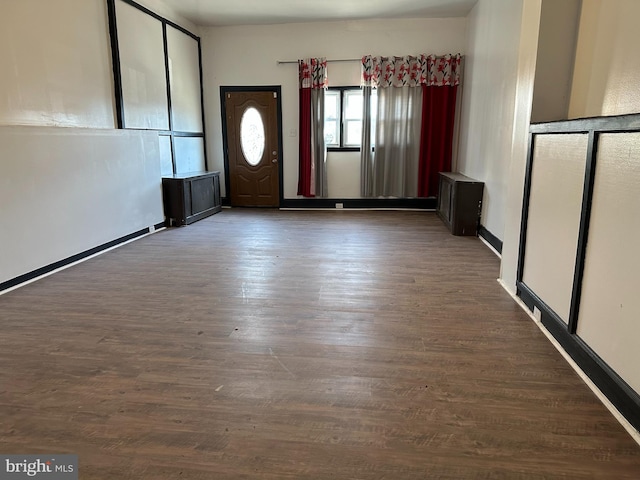 unfurnished room with dark hardwood / wood-style floors