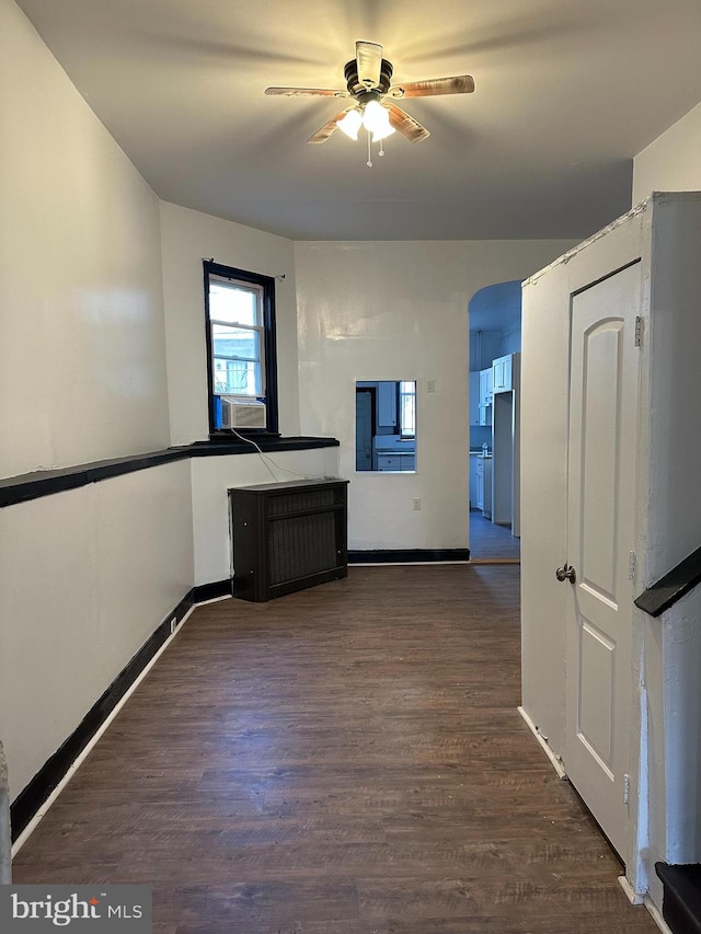 interior space featuring ceiling fan and dark hardwood / wood-style flooring