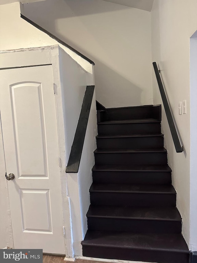 stairway featuring wood-type flooring