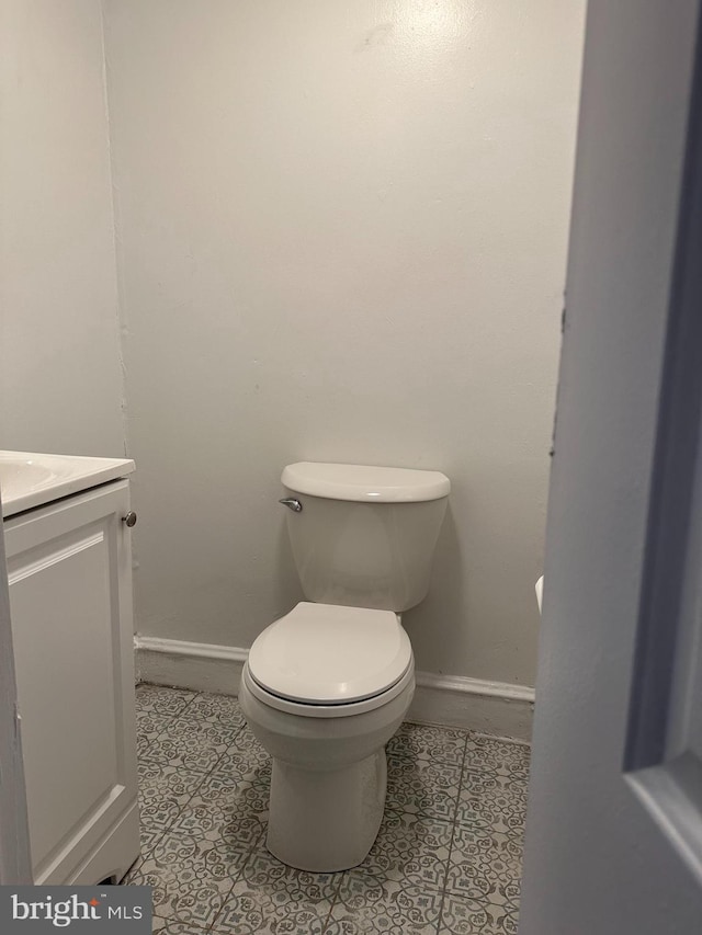 bathroom featuring vanity, tile floors, and toilet