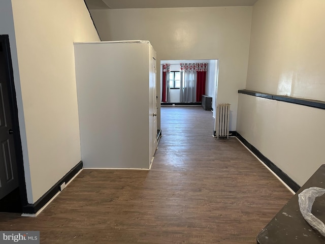 hall featuring dark wood-type flooring and radiator