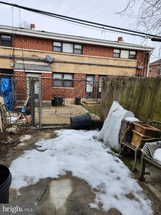 snow covered patio featuring central air condition unit